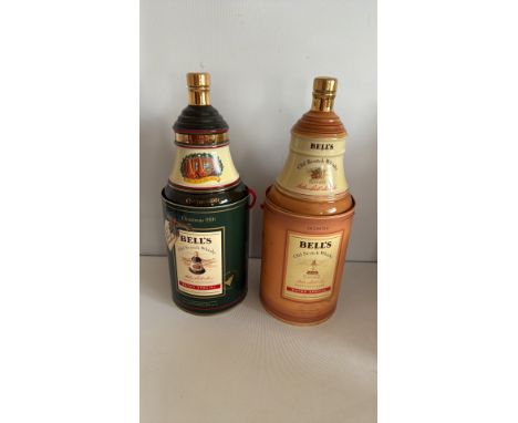 Two Bell's Old Scotch Whisky decanters in original porcelain containers. One dated Christmas 1991, the other undated. Origina