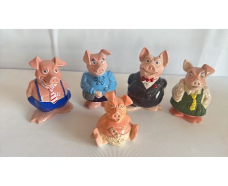 Set of five Wade England ceramic pig figurines, each dressed in different colorful outfits.