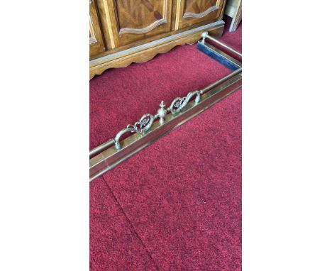 Brass fireplace fender with ornate detailing, from the mid-20th century.