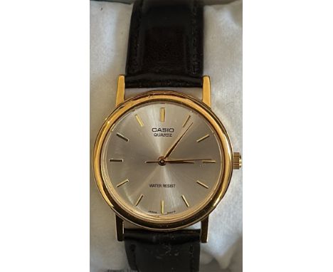 Gents Casio Quartz watch features a gold-tone case, black leather strap, and Japan movement. It is water resistant. Currently