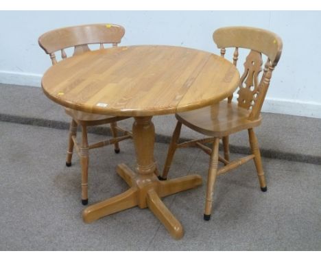 Light oak drop leaf pedestal table and two farmhouse chairs