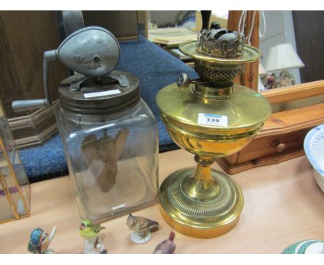 Early 20th century 'Blow' glass butter churn  and a brass oil lamp