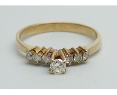 A seven stone diamond ring, marked 14k, 1.7g, M 