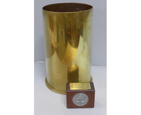A brass shell case dated 1942 and a wooden paperweight from the floor of Building 157, COD, (Chilwell Ordnance Depot), Chilwe