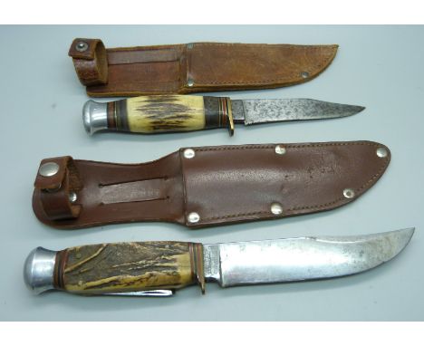 Two knives with antler handles, one with integral tools and one marked Milbro Kampo, made in Sheffield, both with sheaths 