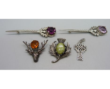 Four Scottish brooches and a silver Celtic cross pendant 