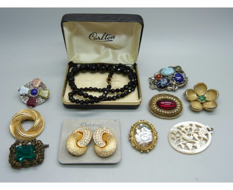 A pair of Christian Dior earrings, a French jet necklace, vintage brooches and a mother of pearl pendant 