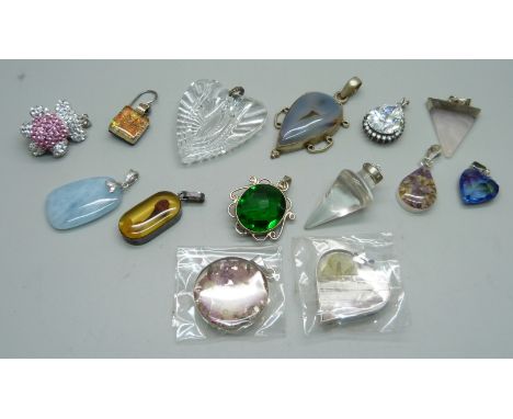 White metal mounted pendants including silver, and a single earring 
