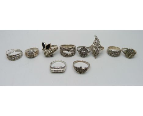 Nine silver and marcasite rings including a .800 example, together with an unmarked white metal ring, 41g 