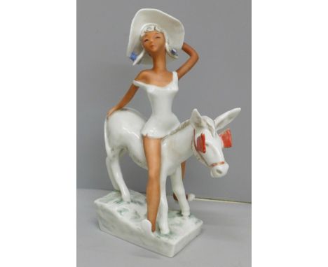 A W. Goebel novelty hand painted figure, circa 1950s 'Lady Atop a Donkey' with red blinkers 