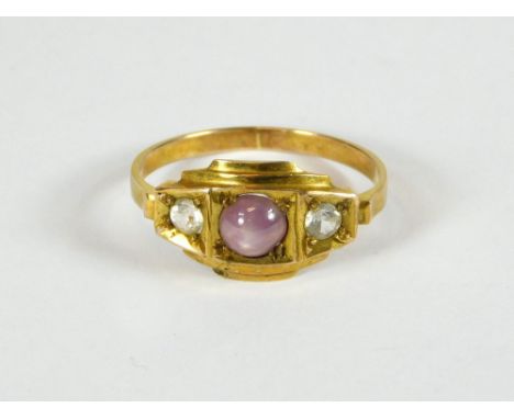 STAR RUBY. A yellow metal ring set a star ruby & two diamonds, (brought back from Burma in the early 1940s, where it was made