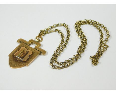 GOLD FOB & CHAIN. A 9ct. gold fob with enamelled Heraldic Emblem of the Bear & Ragged Staff of Warwickshire, hung on a 9ct. g