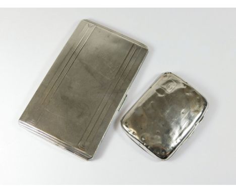 CIGARETTE CASES. A 1940's engine turned large cigarette case & a mid-1930's cigarette case. Approx. 286.5g. (9.2 t.oz.).  Ple