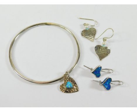 SILVER & OPALITE. A solid silver bangle hung with a silver & opalite charm. Also, two pairs of silver earrings including opal