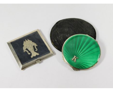 SILVER COMPACTS. A silver & green enamelled powder compact by the Goldsmiths & Silversmiths Company. With slip case. Also, a 