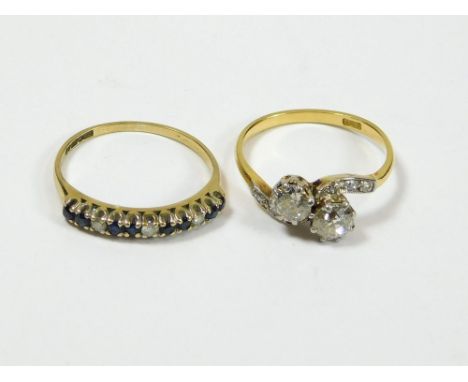 GOLD RINGS. An 18ct. gold & diamond cross-over ring, each of the twin stones approx. 0.30ct. spread. Size N. Also, a 9ct. gol