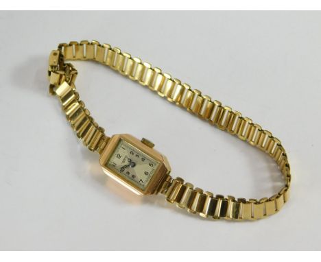 GOLD WATCH. An early 1940s gold cased Dot wristwatch with presentation inscription to the reverse of the case. Gold plated br