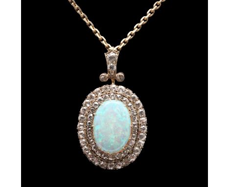 the oval-shaped solid white opal is set within a double surround of round old-cut diamonds in yellow gold, with further diamo