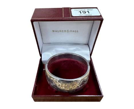 An engraved silver bangle in Walker &amp; Hall box.  CONDITION REPORT: 41g