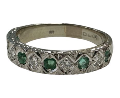 An 18ct white gold emerald and diamond half-eternity ring, size P, 5.2g. 