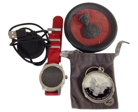A Montblanc Summit smart watch with charger together with a miniature relief plaque of Montgomery and an American $1 key ring