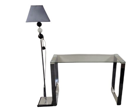 A contemporary glass topped console table on metal legs together with a further contemporary standard lamp with shade 