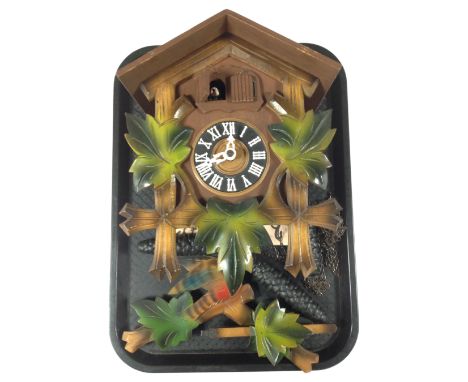 A cuckoo clock with pendulum and weights.