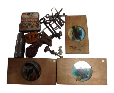 A tray containing antique keys, vintage tins, a 19th century door knocker in the form of a hand, a glass bottle in case, thre