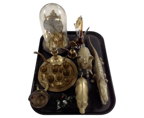 A tray containing Venetian glass animals, brass animal figures, a crocodile nutcracker, a Kundo anniversary clock under shade