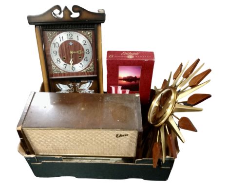 A box containing a valve radio, contemporary eight day wall clock, sunburst clock, six boxed French champagne flutes.