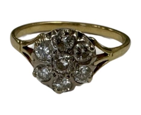 A yellow gold diamond cluster ring, shank unmarked, the total diamond weight estimated at 0.77 carat, size P.  CONDITION REPO