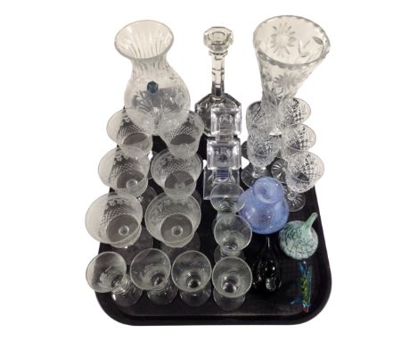 A tray containing assorted glassware including drinking glasses, glass paperweights, Stuart Crystal and Caithness vase, glass