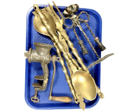 A set of oversized brass utensils with rack, metal candlestick together with vintage national mincer 