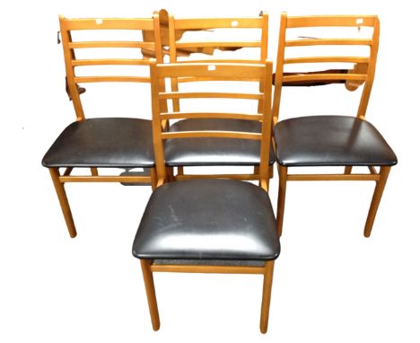 A set of four 20th century ladder backed chairs with black vinyl seats 