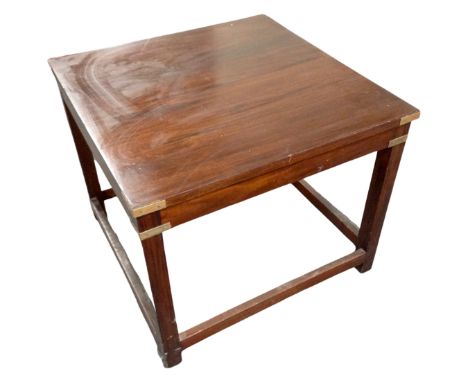 A square lamp table in a mahogany finish, with brass mounts.