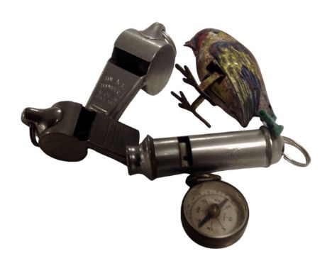 A bag containing a miniature tin plate bird, Acme whistles together with a miniature brass cased compass.