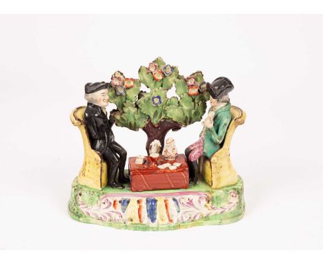 A Staffordshire pearlware figure group of 'Dr Syntax playing cards', circa 1830, of Sherratt type, modelled as two men at a t