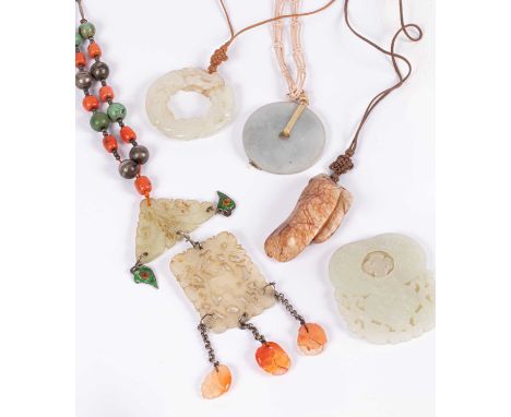 A Chinese jade pendant necklace, pierced with enamel and soapstone drops, the white metal chain with coral and turquoise bead