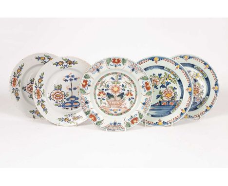 Five English delftware polychrome plates, circa 1760 probably Bristol, painted with peony, rocks and bamboo, 23cm diameter