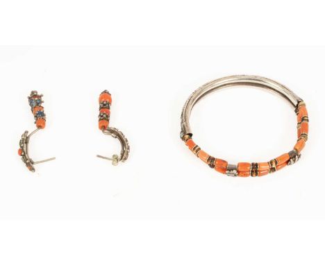 A Chinese white metal bangle with coral and bone beads, together with a pair of matching white metal and coral earrings