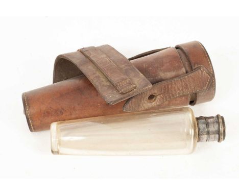 A hunting flask in a leather saddle case, the plated cover marked Harrods Ltd., 17.5cm long