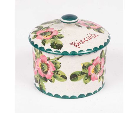 A Wemyss cylindrical biscuit box and cover painted sprays of pink dogroses and green foliage, painted and impressed marks, 12
