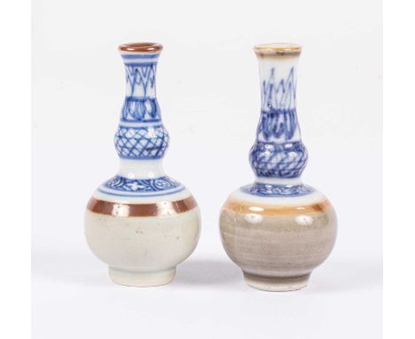 Two Chinese miniature double-gourd vases, Kangxi, decorated to the neck and shoulder in blue and white above a cafe-au-lait b