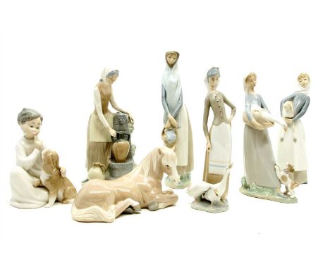 A collection of Lladro figures, to include a lady with geese, a child with dog, a lady with a lamb, and a similar Nao figure