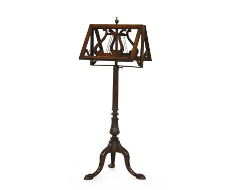 A 19th century rosewood duet music stand, the adjustable lecturn with pierced lyre motifs on reeded column and tripod base, 1