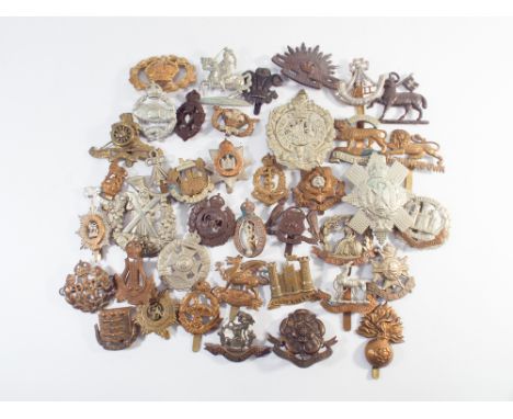 Collection of 40 British Army badges to include the Essex Regiment, Eniskillen, Royal Warwickshire, Notts and Derby Artillery