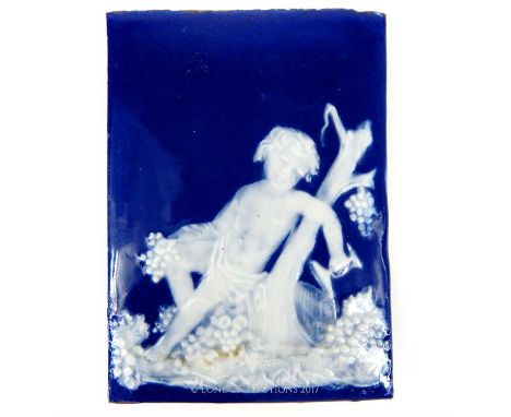 A 19th century, French, Limoges-style, rectangular, porcelain plaque depicting in relief a youth / baccante amongst vines and