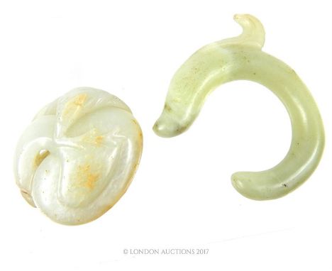 Two Chinese carved jade items, the first in the form of a serpent, 7 x 6.5 x 1cm, the second depicting a bird with foliage in