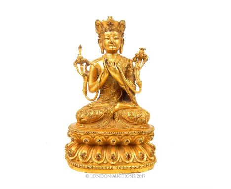 A gilt bronze Buddha figure, seated upon a lotus base, 18 x 11 x 8cm.