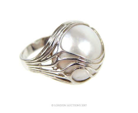 A boxed, 18 ct white gold, South Sea pearl cocktail ring, composed of a large, central South Sea pearl with white gold wire-w